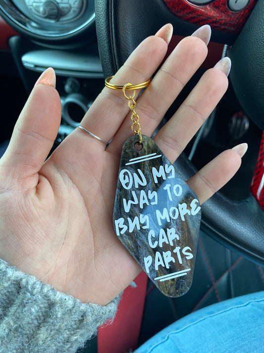 “On my way to buy more car parts” Motel Style Keyring